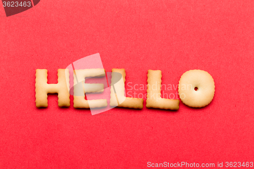 Image of Word hello cookie over the red background