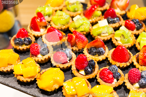 Image of Different fruit tart in shop
