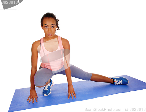 Image of Beautiful African American woman stretching.