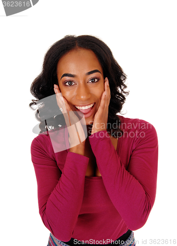 Image of African woman with hands on face.