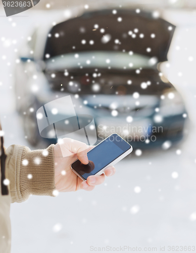 Image of closeup of man with broken car and smartphone