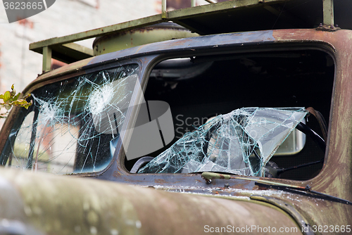 Image of war truck with broken windshield glass outdoors