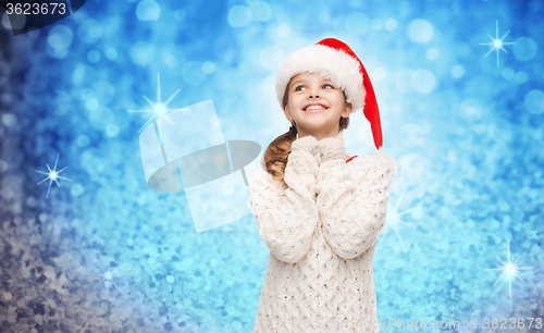 Image of dreaming girl in santa helper hat