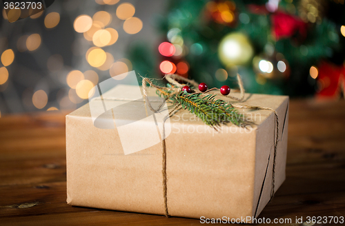 Image of close up of christmas gift with fir brunch