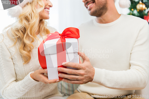 Image of close up of couple with christmas gift at home