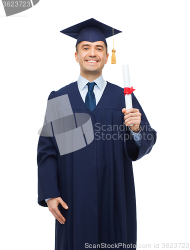 Image of smiling adult student in mortarboard with diploma