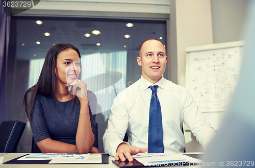 Image of smiling business people meeting in office