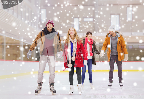 Image of happy friends on skating rink