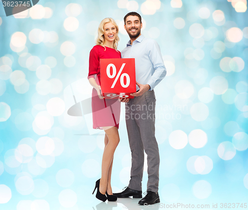 Image of happy couple with red sale sign