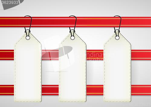 Image of white price tags on red ribbon