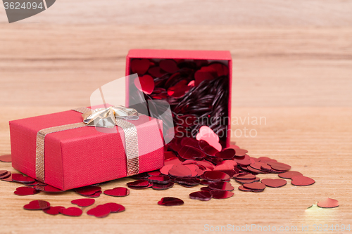 Image of Red hearts confetti on wooden background