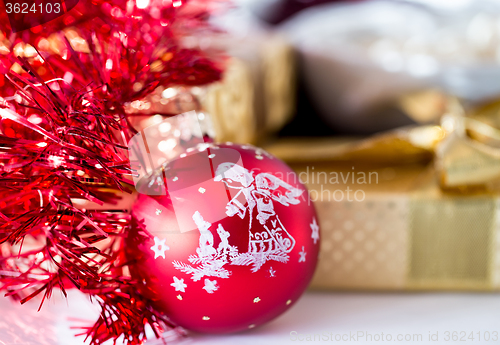 Image of christmas decoration and golden box with ribbon