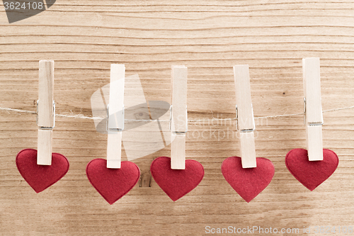 Image of Red fabric heart hanging on the clothesline