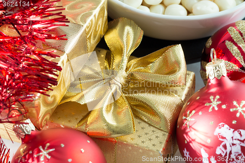 Image of christmas decoration and golden box with ribbon