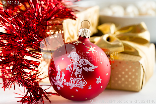 Image of christmas decoration and golden box with ribbon