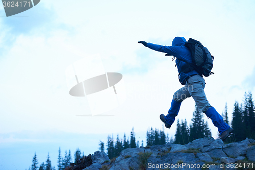 Image of advanture man with backpack hiking