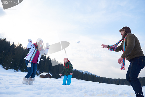 Image of happy family playing together in snow at winter