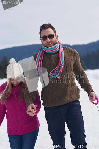 Image of happy young couple having fun on fresh show on winter vacation