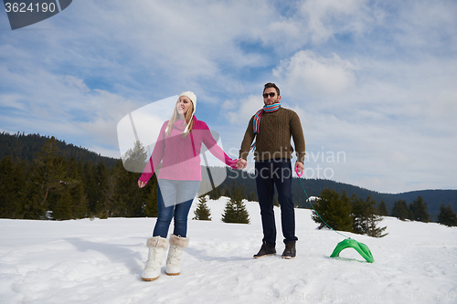 Image of happy young couple having fun on fresh show on winter vacation