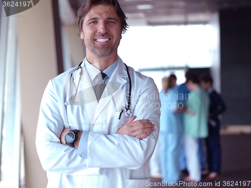 Image of group of medical staff at hospital, doctor in front of team