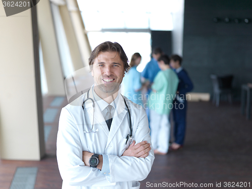 Image of group of medical staff at hospital, doctor in front of team