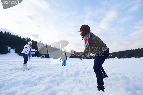 Image of happy family playing together in snow at winter