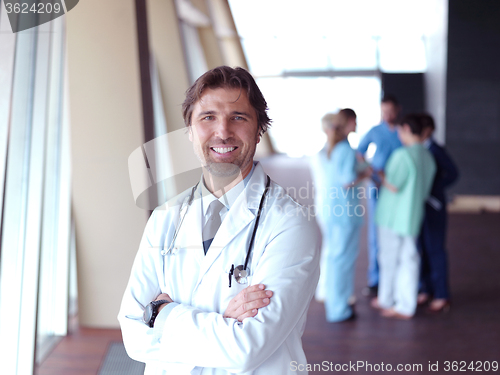 Image of group of medical staff at hospital, doctor in front of team