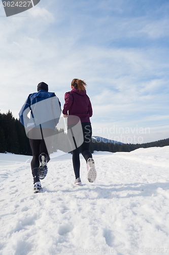 Image of couple jogging outside on snow