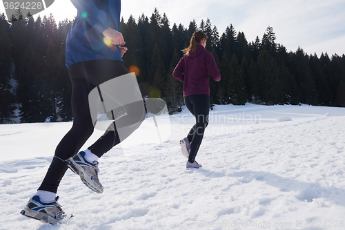 Image of couple jogging outside on snow