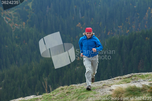 Image of advanture man with backpack hiking