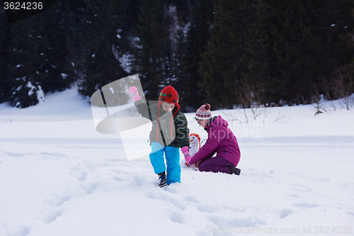 Image of happy family building snowman