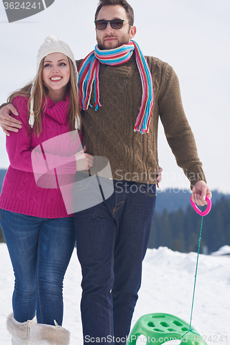 Image of happy young couple having fun on fresh show on winter vacation