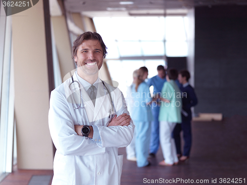 Image of group of medical staff at hospital, doctor in front of team
