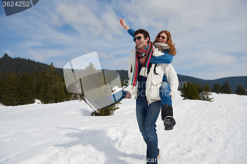 Image of happy young couple having fun on fresh show on winter vacation