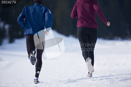 Image of couple jogging outside on snow