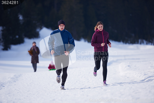 Image of couple jogging outside on snow