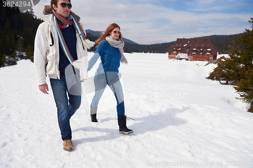 Image of happy young couple having fun on fresh show on winter vacation