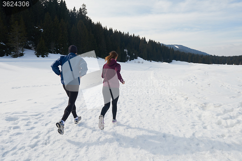 Image of couple jogging outside on snow