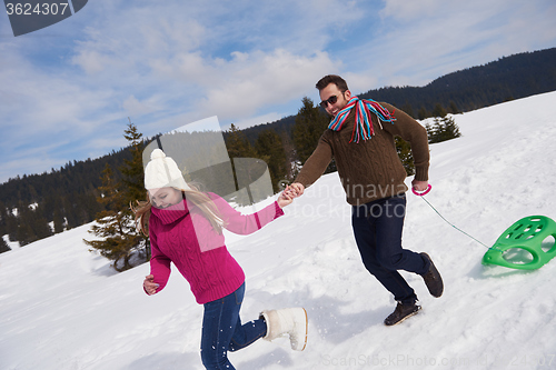 Image of happy young couple having fun on fresh show on winter vacation