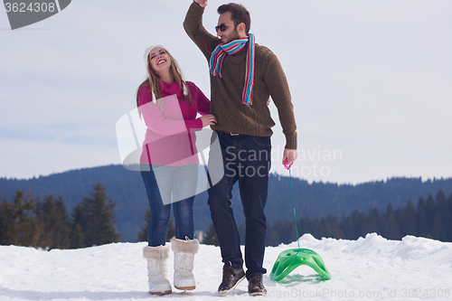 Image of happy young couple having fun on fresh show on winter vacation