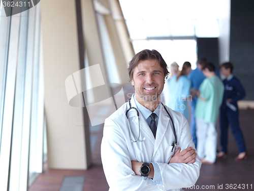Image of group of medical staff at hospital, doctor in front of team
