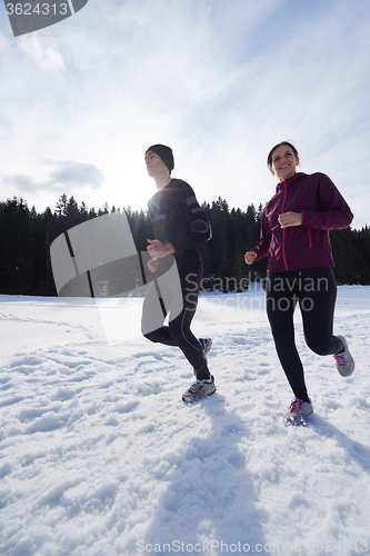 Image of couple jogging outside on snow