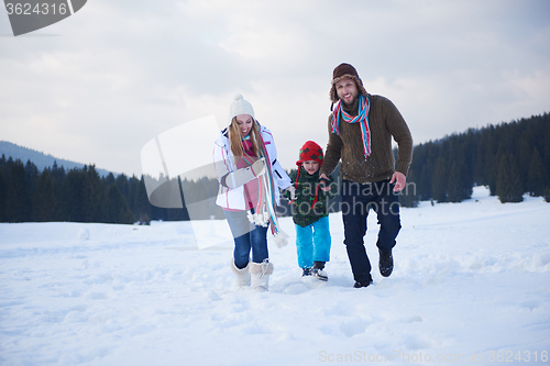 Image of happy family playing together in snow at winter