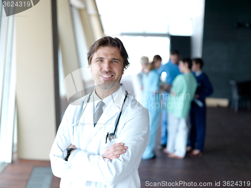Image of group of medical staff at hospital, doctor in front of team