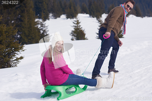 Image of happy young couple having fun on fresh show on winter vacation