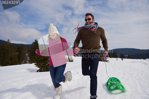 Image of happy young couple having fun on fresh show on winter vacation