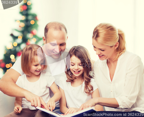 Image of happy family with book at home