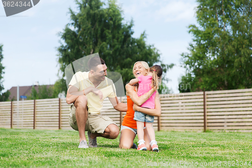 Image of happy family hugging outdoors