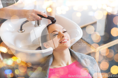 Image of happy young woman at hair salon