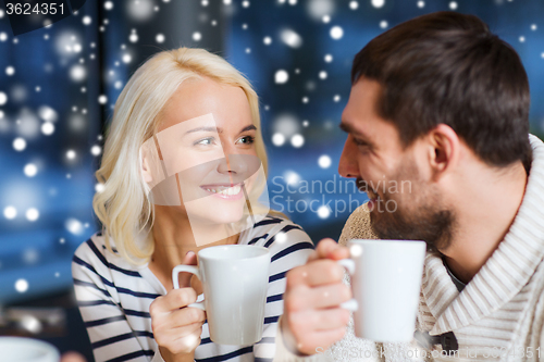 Image of happy couple meeting and drinking tea or coffee